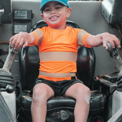 Boy in machinery wearing organge high visibility t-shirt