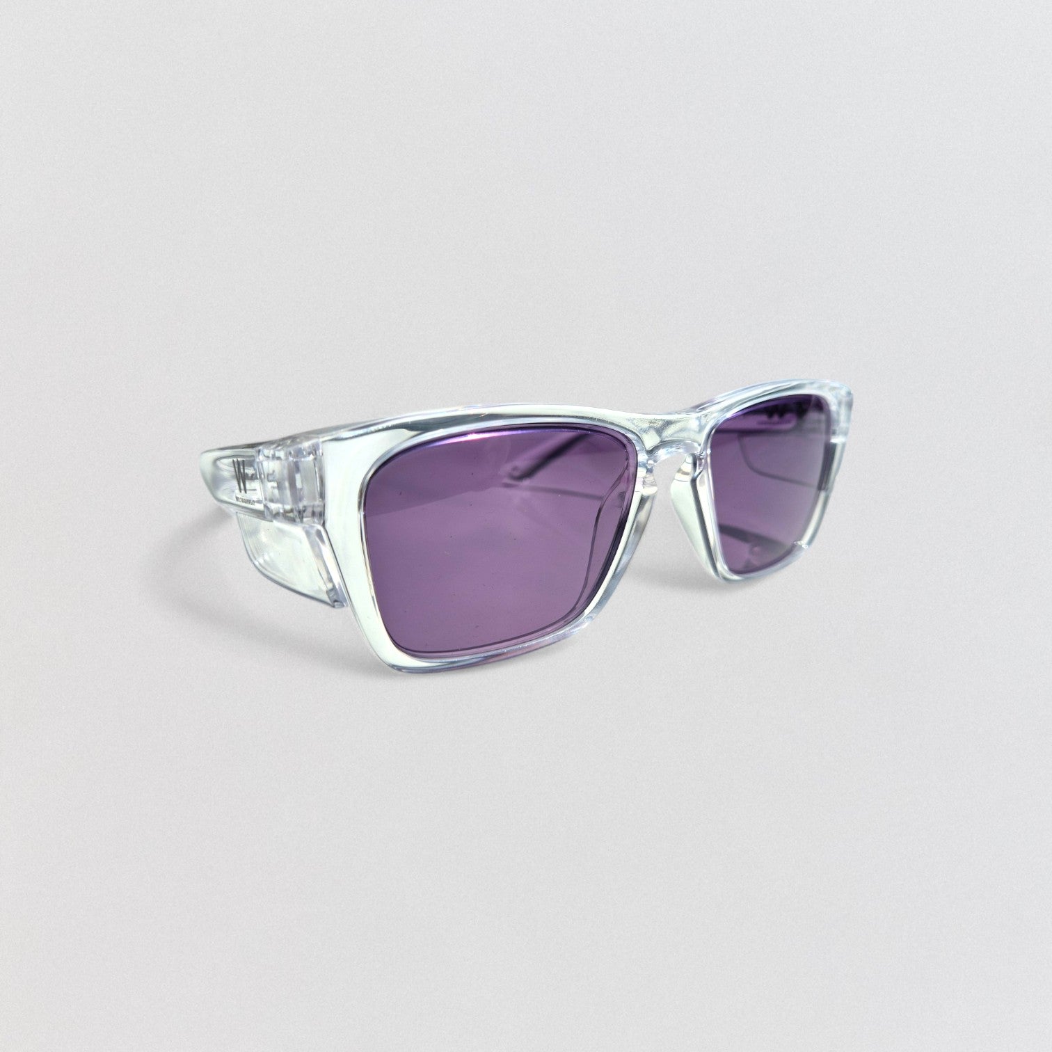 A pair of clear, rectangular-framed, photochromic safety glasses with purple-tinted lenses.
