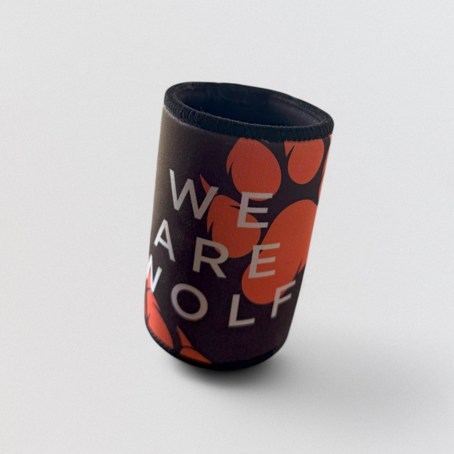 A neoprene magnetic stubby holder with the text 'WE ARE WOLF' printed in white and orange on a black background.