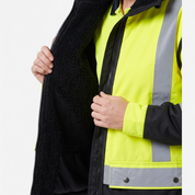 Ironhide 3-in-1 work jacket lifestyle shot showing women's specific fit on worksite