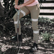Up Close photo of a woman wearing khaki wolf workpants