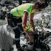 Woman gardening wearing Wolf Workwear Trooper Workpants in black.