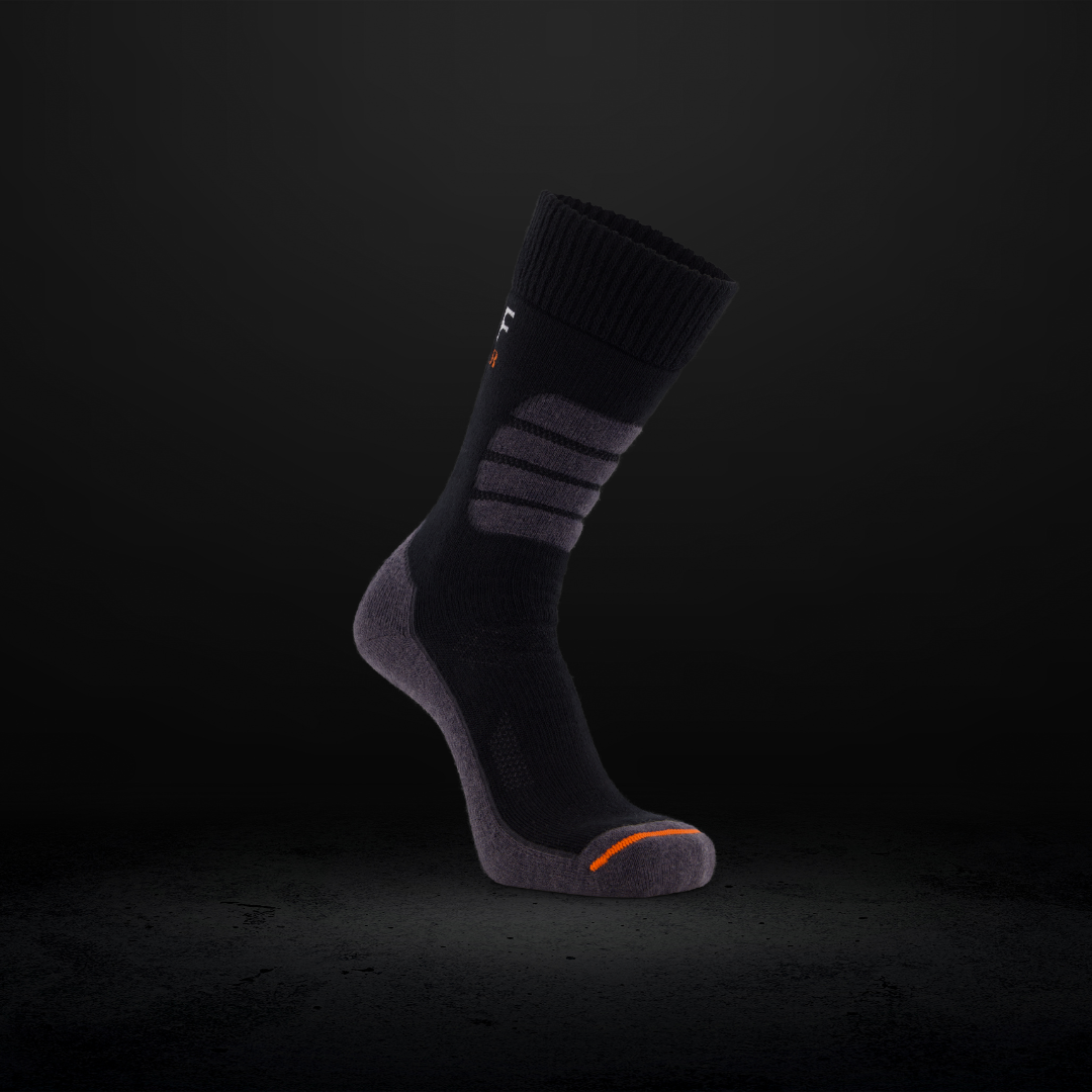 Black work sock with orange accents on a dark background