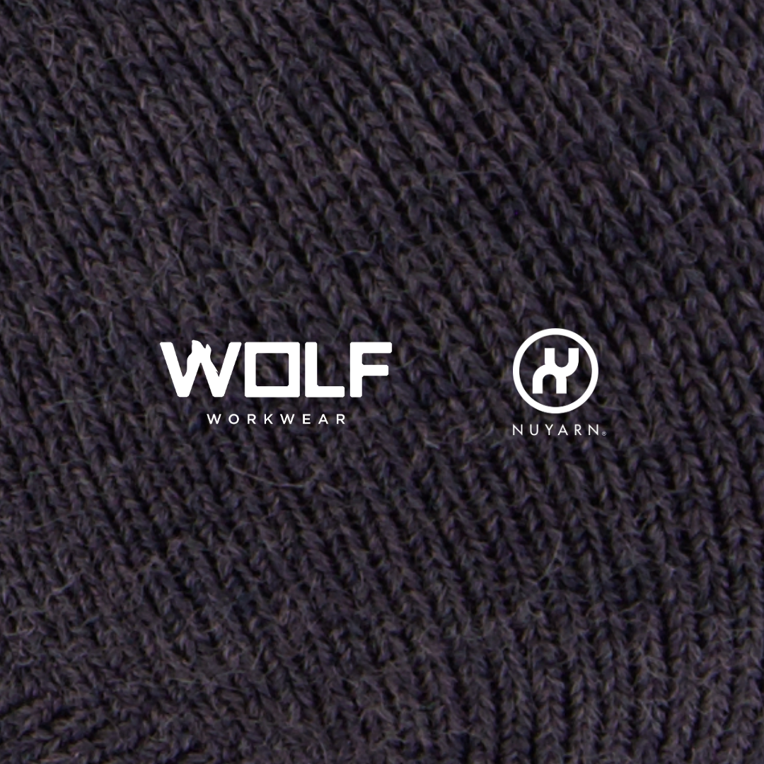 Close-up of a textured wool fabric with 'Wolf Workwear' and 'Nuyarn' logos.