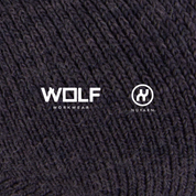 Close-up of a textured wool fabric with 'Wolf Workwear' and 'Nuyarn' logos.