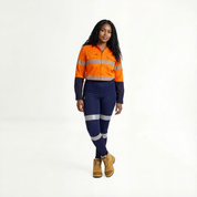 Person wearing an orange and blue work outfit with reflective elements on a white background
