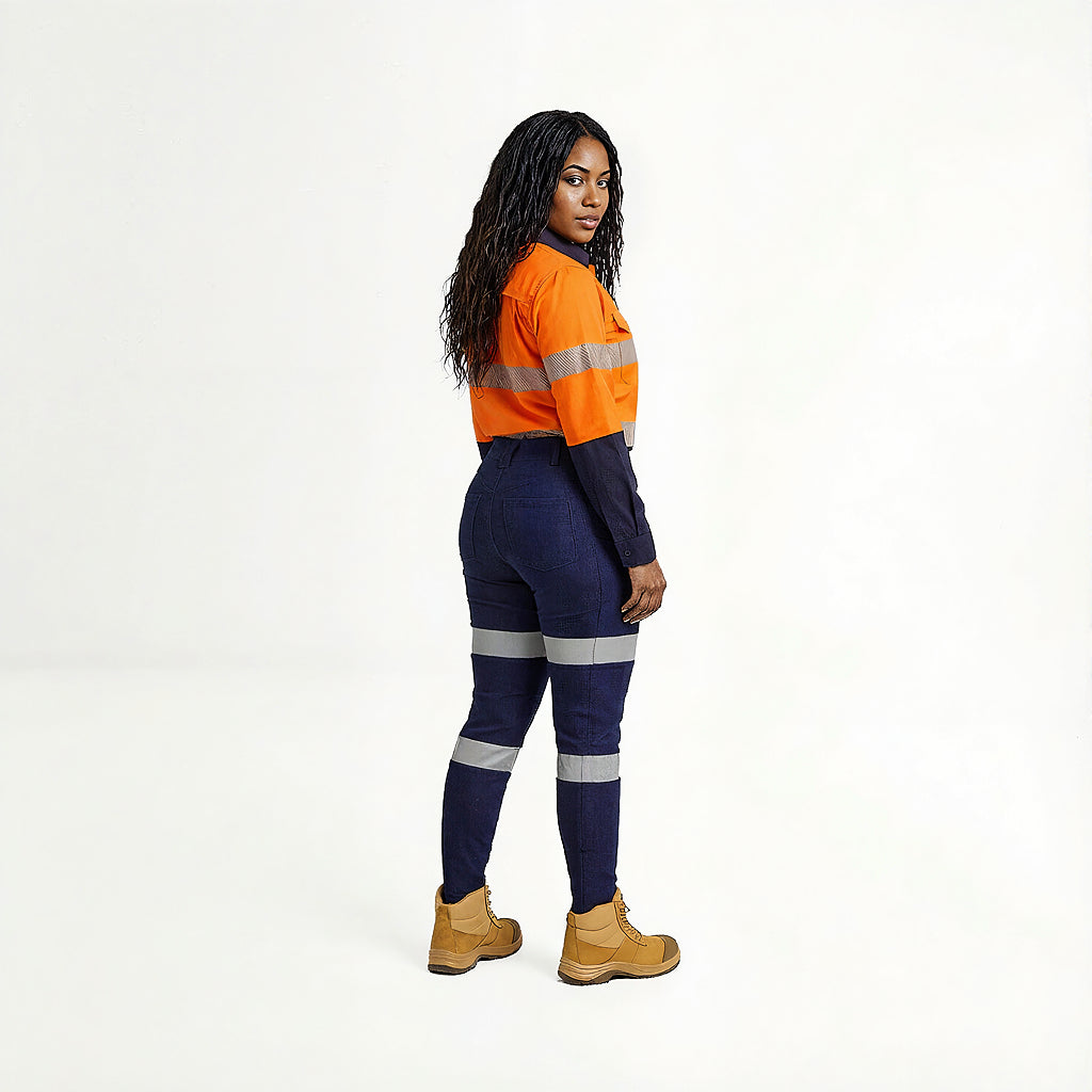 Person wearing an orange and navy high-visibility work outfit on a white background