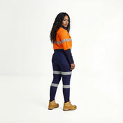 Person wearing an orange and navy high-visibility work outfit on a white background