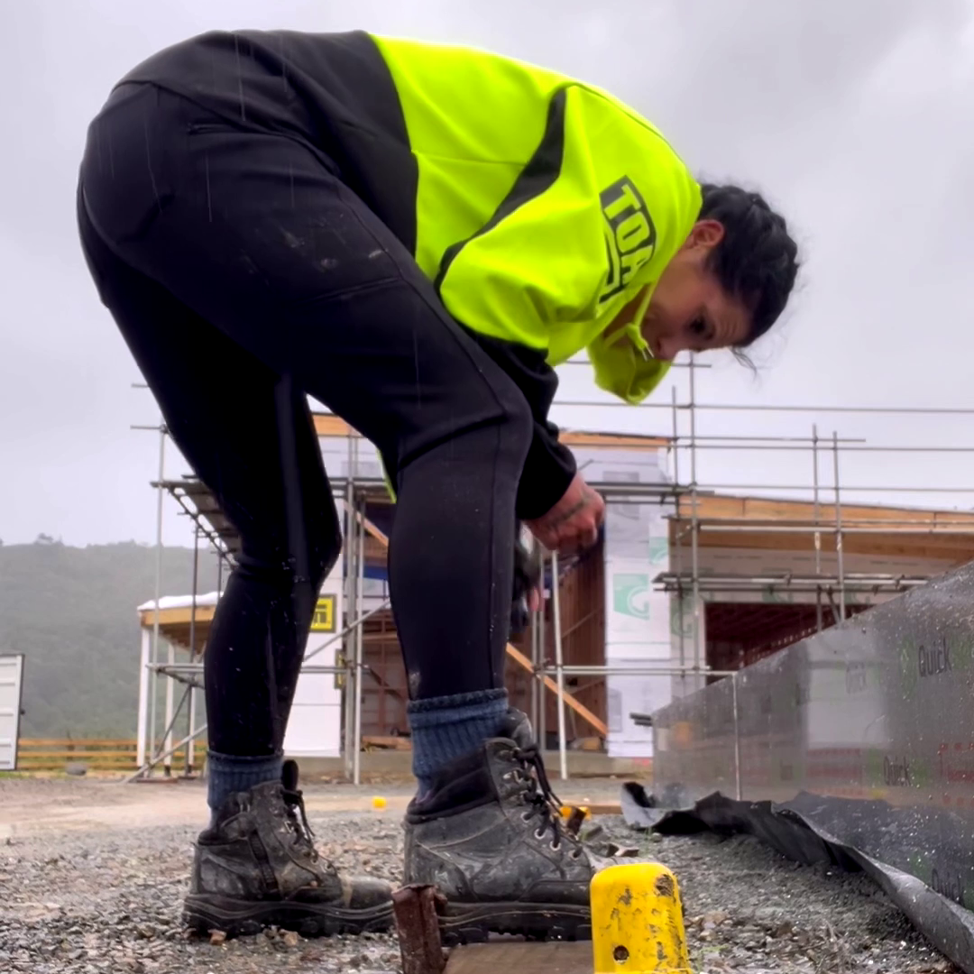 Person in winter workwear leggings working on a construction site